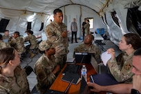 U.S. Air Force Master Sgt. Michael H. Reyes, 11th Contracting Squadron senior enlisted leader, instructs a group of Airmen during a field training exercise at Joint Base Anacostia-Bolling, Washington, D.C., Aug. 19, 2025. The 11th CONS executed annual requirements during a three-day exercise that included briefing the wing commander. (U.S. Air Force photo by Staff Sgt. Jordan Powell)