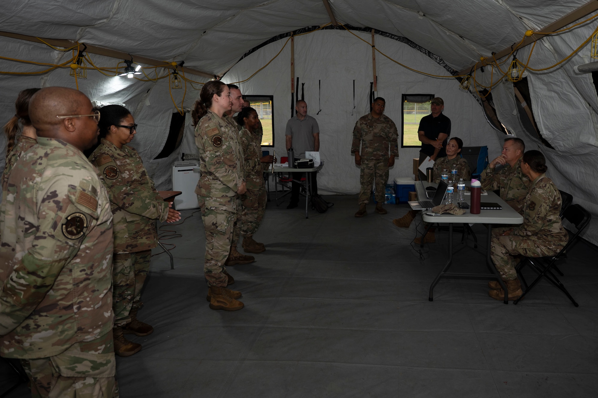 U.S. Airmen with the 11th Contracting Squadron brief U.S. Air Force Col. James M. Clark, commander of Joint Base Anacostia-Bolling and the 11th Wing, Col. Angelique Nelson, 11th Mission Support Group commander, and Lt. Col. Rebecca Ban, 11th Contracting Squadron commander, at JBAB, Washington, D.C. Aug. 19, 2025. The Airmen processed approximately 40 scenarios and received live feedback from both the inspection team and senior leadership to ensure deployment readiness. (U.S. Air Force photo by Staff Sgt. Jordan Powell)