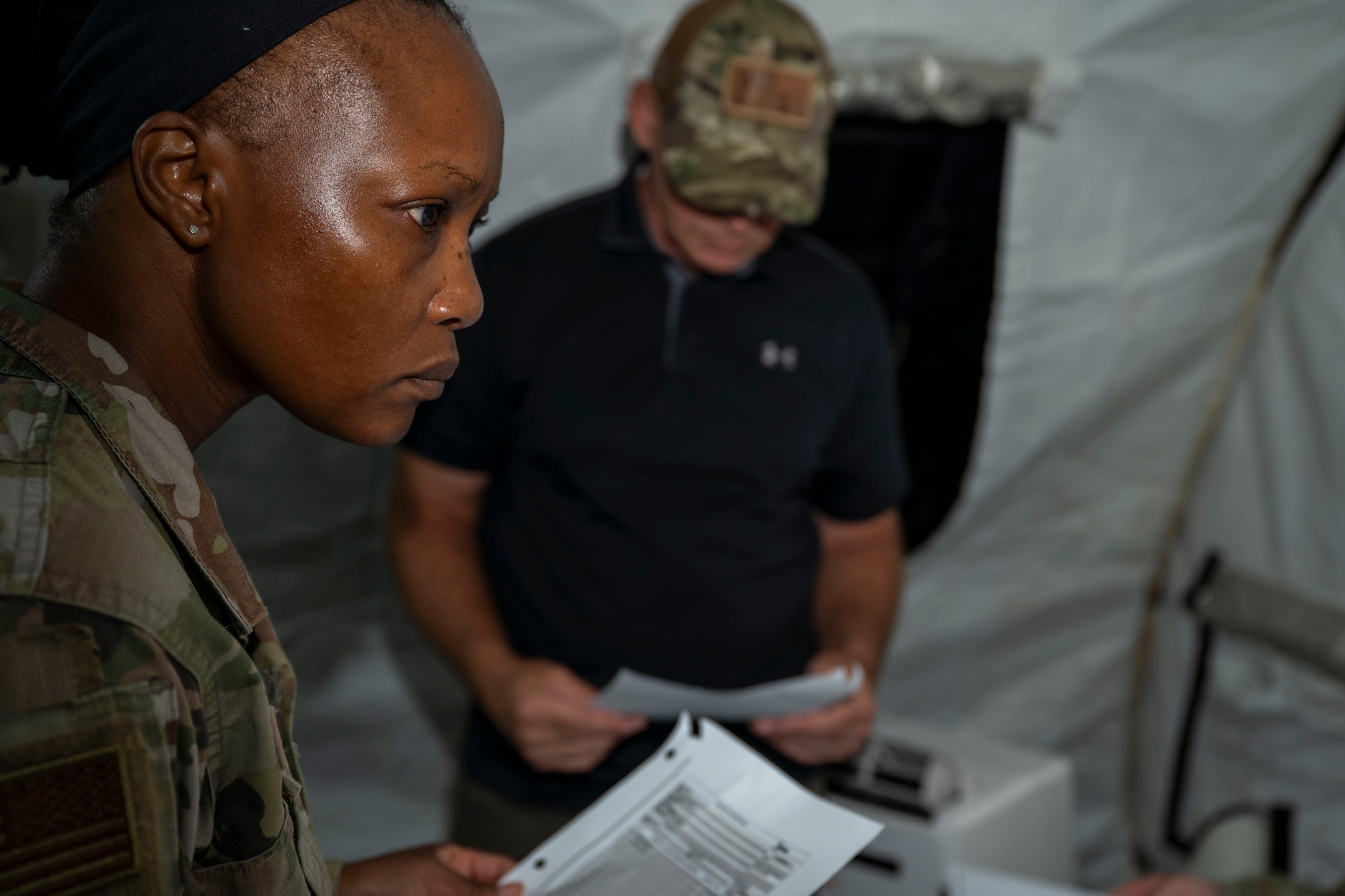 U.S. Air Force Senior Airman Anida Dublin, an 11th Contracting Squadron contracting specialist, works on a problem set with the inspection team at Joint Base Anacostia-Bolling, Washington, D.C., Aug. 19, 2025. Dublin and her team handled approximately 40 scenarios in the three-day exercise to ensure deployment capability. (U.S. Air Force photo by Staff Sgt. Jordan Powell)
