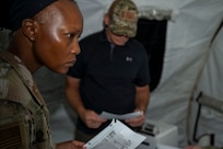 U.S. Air Force Senior Airman Anida Dublin, an 11th Contracting Squadron contracting specialist, works on a problem set with the inspection team at Joint Base Anacostia-Bolling, Washington, D.C., Aug. 19, 2025. Dublin and her team handled approximately 40 scenarios in the three-day exercise to ensure deployment capability. (U.S. Air Force photo by Staff Sgt. Jordan Powell)