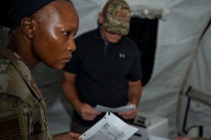 U.S. Air Force Senior Airman Anida Dublin, an 11th Contracting Squadron contracting specialist, works on a problem set with the inspection team at Joint Base Anacostia-Bolling, Washington, D.C., Aug. 19, 2025. Dublin and her team handled approximately 40 scenarios in the three-day exercise to ensure deployment capability. (U.S. Air Force photo by Staff Sgt. Jordan Powell)
