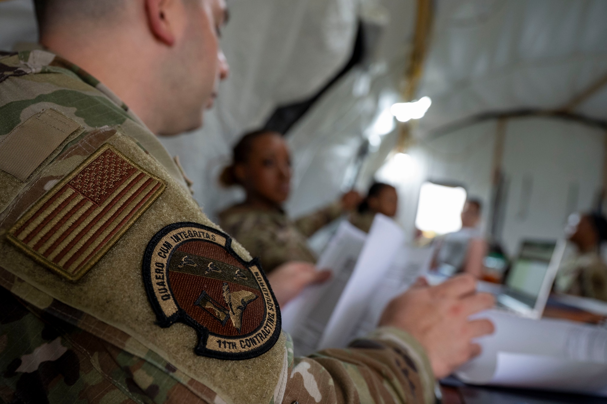U.S. Air Force Tech. Sgt. Kristopher Densmore, an 11th Contracting Squadron contracting specialist, reviews documents at Joint Base-Anacostia-Bolling, Washington, D.C., Aug. 19, 2025. Densmore and his team handled approximately 40 scenarios in the three-day exercise to ensure deployment capability. (U.S. Air Force photo by Staff Sgt. Jordan Powell)
