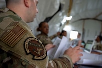 U.S. Air Force Tech. Sgt. Kristopher Densmore, an 11th Contracting Squadron contracting specialist, reviews documents at Joint Base-Anacostia-Bolling, Washington, D.C., Aug. 19, 2025. Densmore and his team handled approximately 40 scenarios in the three-day exercise to ensure deployment capability. (U.S. Air Force photo by Staff Sgt. Jordan Powell)