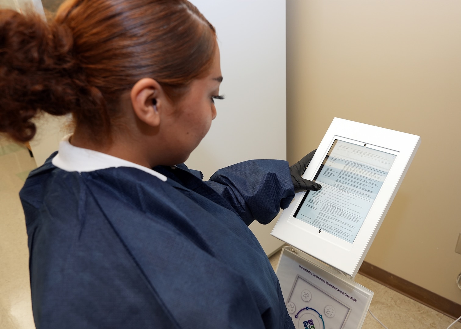 JOINT BASE SAN ANTONIO-FORT SAM HOUSTON - (Aug. 21, 2025) – Hospital Corpsman 3rd Class Nimsi Hernandez, of Lancaster, Calif., assigned to Naval Medical Research Unit (NAMRU) San Antonio, utilizes a digital kiosk to read a Safety Data Sheet (SDS) at the Battlefield Health and Trauma Research Institute. NAMRU San Antonio recently procured a digital SDS database system for use on non-networked computer tablets to replace all physical SDS binders. The Occupational Safety and Health Administration Hazard Communication standard 1910.1200 requires SDSs to be readily accessible during each work shift for all hazardous chemicals in the workplace. NAMRU San Antonio, part of Navy Medicine Research & Development (NMR&D), conducts gap-driven combat casualty care, craniofacial, and directed energy research in support of Navy, Marine Corps and joint U.S. warfighter health readiness and lethality while engaged in routine and expeditionary operations. (U.S. Navy photo by Burrell Parmer, NAMRU San Antonio Public Affairs/Released)