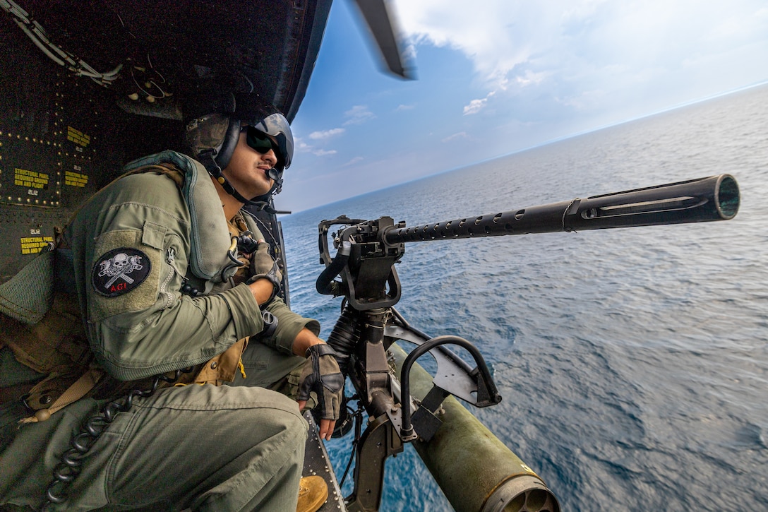 U.S. Marine Corps Sgt. Angel Hernandez, a crew chief with Marine Light Attack Helicopter Squadron (HMLA) 775, Marine Aircraft Group 41, 4th Marine Aircraft Wing, rides in a Utility Helicopter-1Y during a simulated visit, board, search and seizure operation for Training Exercise Northern Strike at Camp Grayling, Michigan, Aug. 7, 2025. Northern Strike is designed to validate readiness of a Joint Reserve force to cover unique Marine Corps Reserve capabilities and support to active components on a large scale. (U.S. Marine Corps photo by Cpl. Aaron TorresLemus)