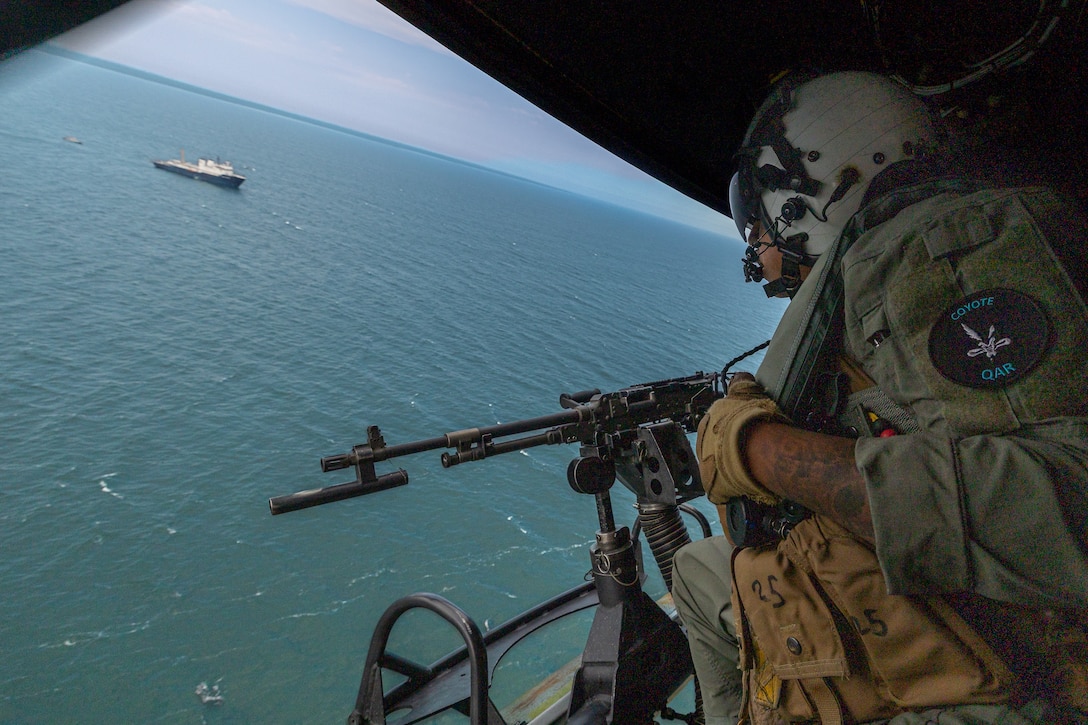 U.S. Marine Corps Gunnery Sgt. Jose Espitia, a flight line mechanic with Marine Light Attack Helicopter Squadron (HMLA) 775, Marine Aircraft Group 41, 4th Marine Aircraft Wing, identifies a U.S. Border Patrol ship used to simulate a visit, board, search and seizure operation for Training Exercise Northern Strike at Camp Grayling, Michigan, Aug. 7, 2025. Northern Strike is designed to validate readiness of a Joint Reserve force to cover unique Marine Corps Reserve capabilities and support to active components on a large scale. (U.S. Marine Corps photo by Cpl. Aaron TorresLemus)