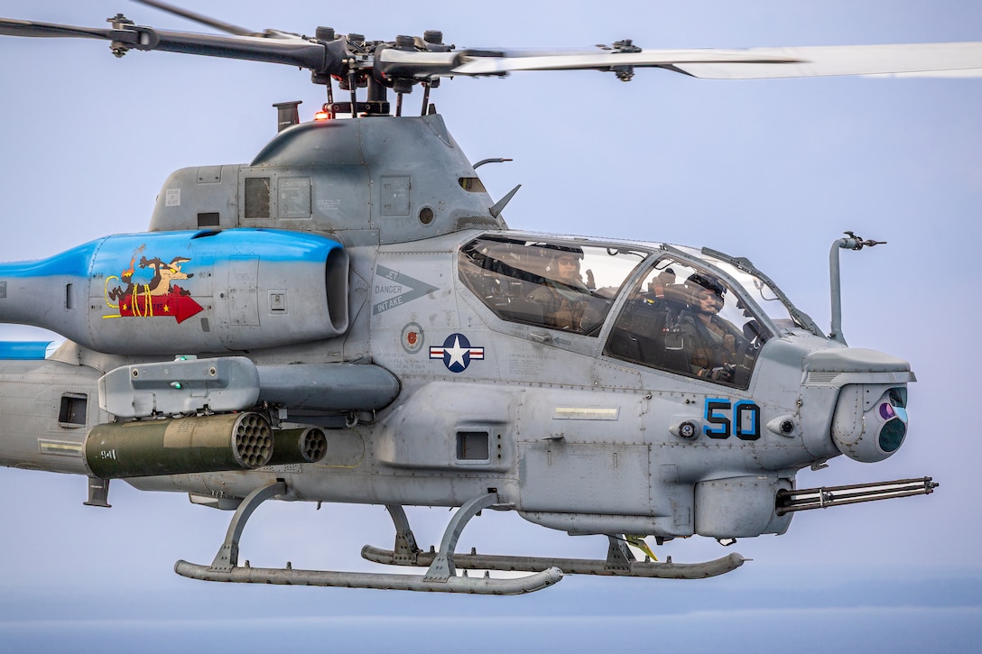 U.S. Marine Corps Lt. Col. Jacinto Guevara, left, commanding officer and Maj. Asher Johnson, right, an AH-1Z viper attack helicopter pilot, with Marine Light Attack Helicopter Squadron 775, Marine Aircraft Group 41, 4th Marine Aircraft Wing, fly an AH-1Z Viper attack helicopter during a simulated visit, board, search and seizure operation for Training Exercise Northern Strike at Camp Grayling, Michigan, Aug. 7, 2025. Northern Strike is designed to validate readiness of a Joint Reserve force to cover unique Marine Corps Reserve capabilities and support to active components on a large scale. (U.S. Marine Corps photo by Cpl. Aaron TorresLemus)