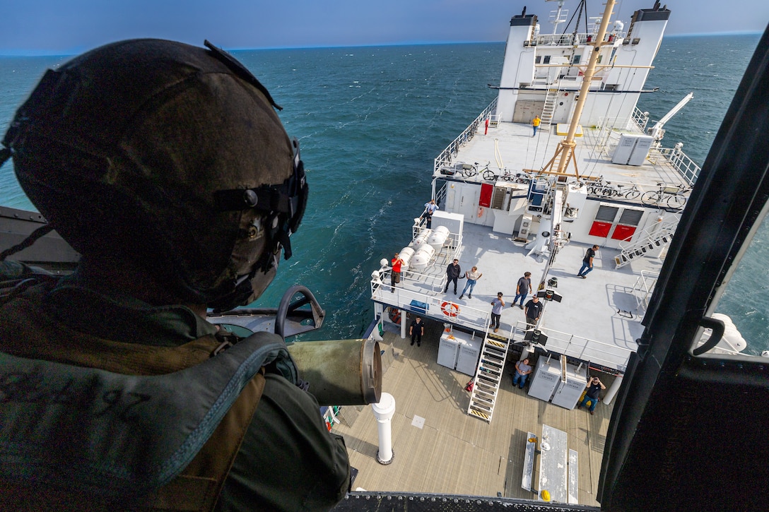 U.S. Marine Corps Sgt. Angel Hernandez, a crew chief with Marine Light Attack Helicopter Squadron (HMLA) 775, Marine Aircraft Group 41, 4th Marine Aircraft Wing, looks down at a U.S. Border Patrol ship as a UH-1Y Venom approaches the ship to simulate a visit, board, search and seizure operation in support of Training Exercise Northern Strike at Camp Grayling, Michigan, Aug. 7, 2025. Northern Strike is designed to validate readiness of a Joint Reserve force to cover unique Marine Corps Reserve capabilities and support to active components on a large scale. (U.S. Marine Corps photo by Cpl. Aaron TorresLemus)