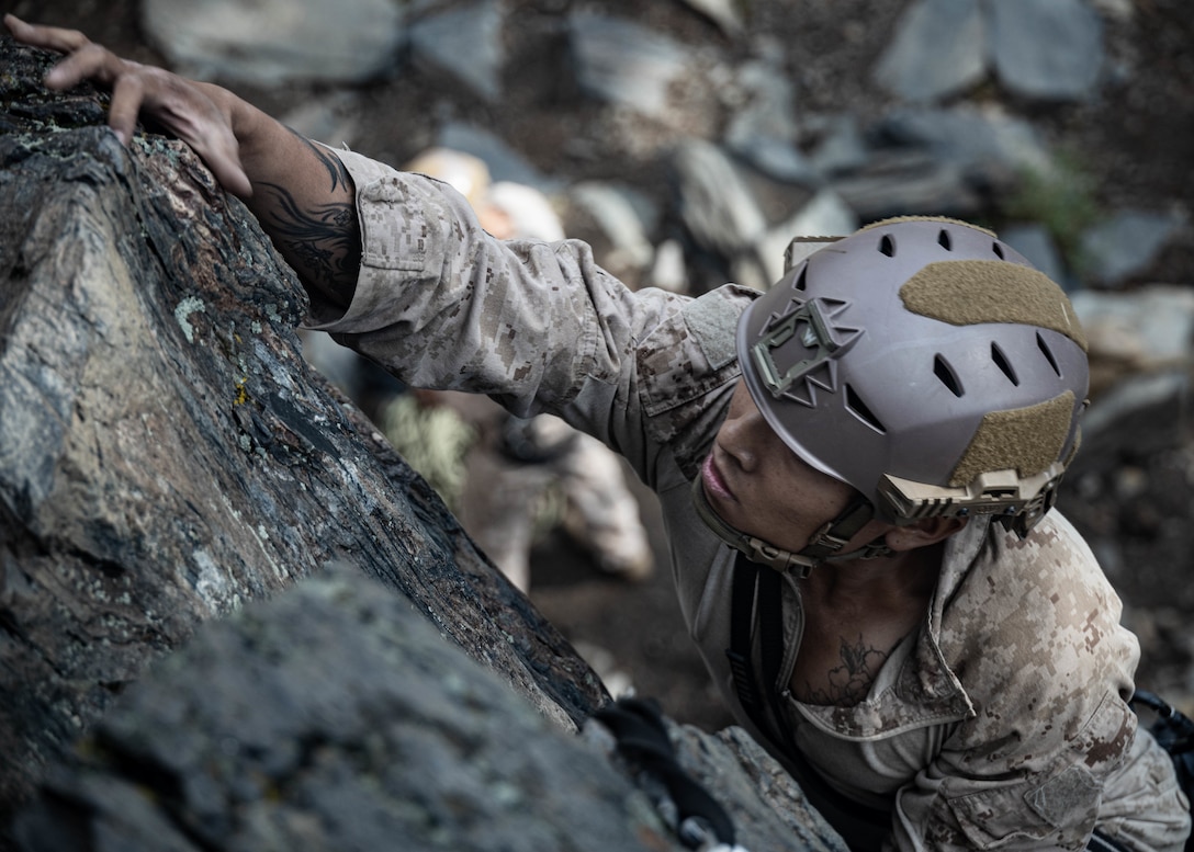 U.S. Marine Corps Lance Cpl. Nathan Hoang, a rifleman with 1st Battalion, 1st Marine Regiment, 1st Marine Division, I Marine Expeditionary Force, climbs up a cliff during Assault Climbers Course 25-3 at Marine Corps Mountain Warfare Training Center Bridgeport, California, Aug. 24, 2025. ACC is a multi-week course that exposes students to rope climbing techniques and procedures, increasing mobility and lethality in littoral, mountainous and urban terrain. (U.S. Marine Corps photo by Lance Cpl. Luke Rodriguez)