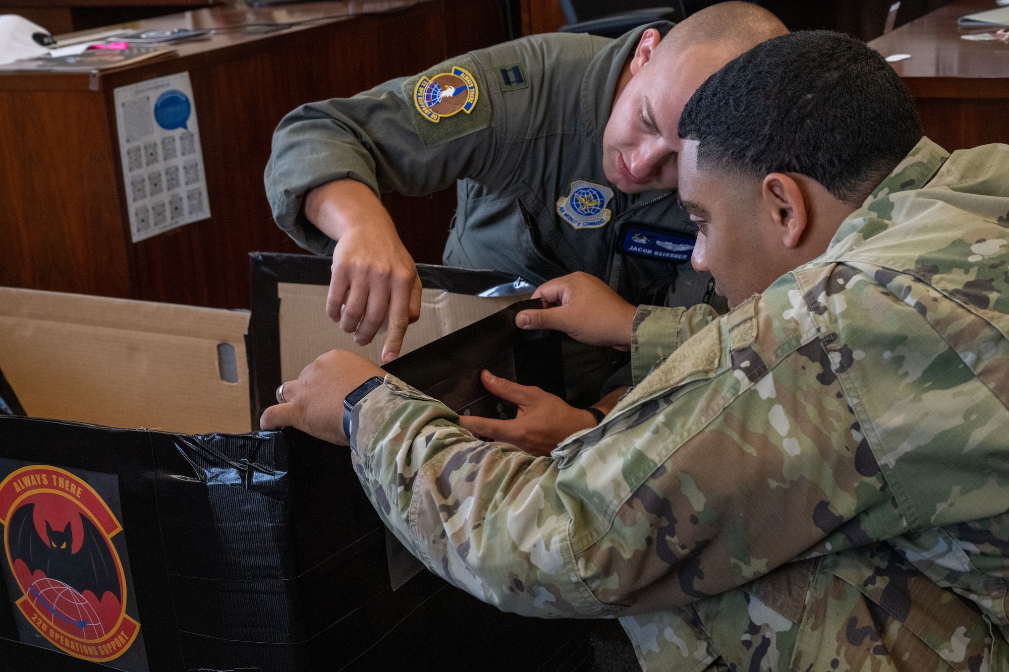 Capt. Jacob Reissner, 344th Air Refueling Squadron KC-46A Pegasus pilot, and Senior Airman Isaiah Paulino, 22nd Operations Support Squadron commander’s support staff technician, build a boat for McConnell’s cardboard regatta race at McConnell Air Force Base, Kansas, Aug. 19, 2025. Participants were permitted cardboard, tape, and paint for building their competition boats. (U.S. Air Force photo by Airman 1st Class Paula Arce)