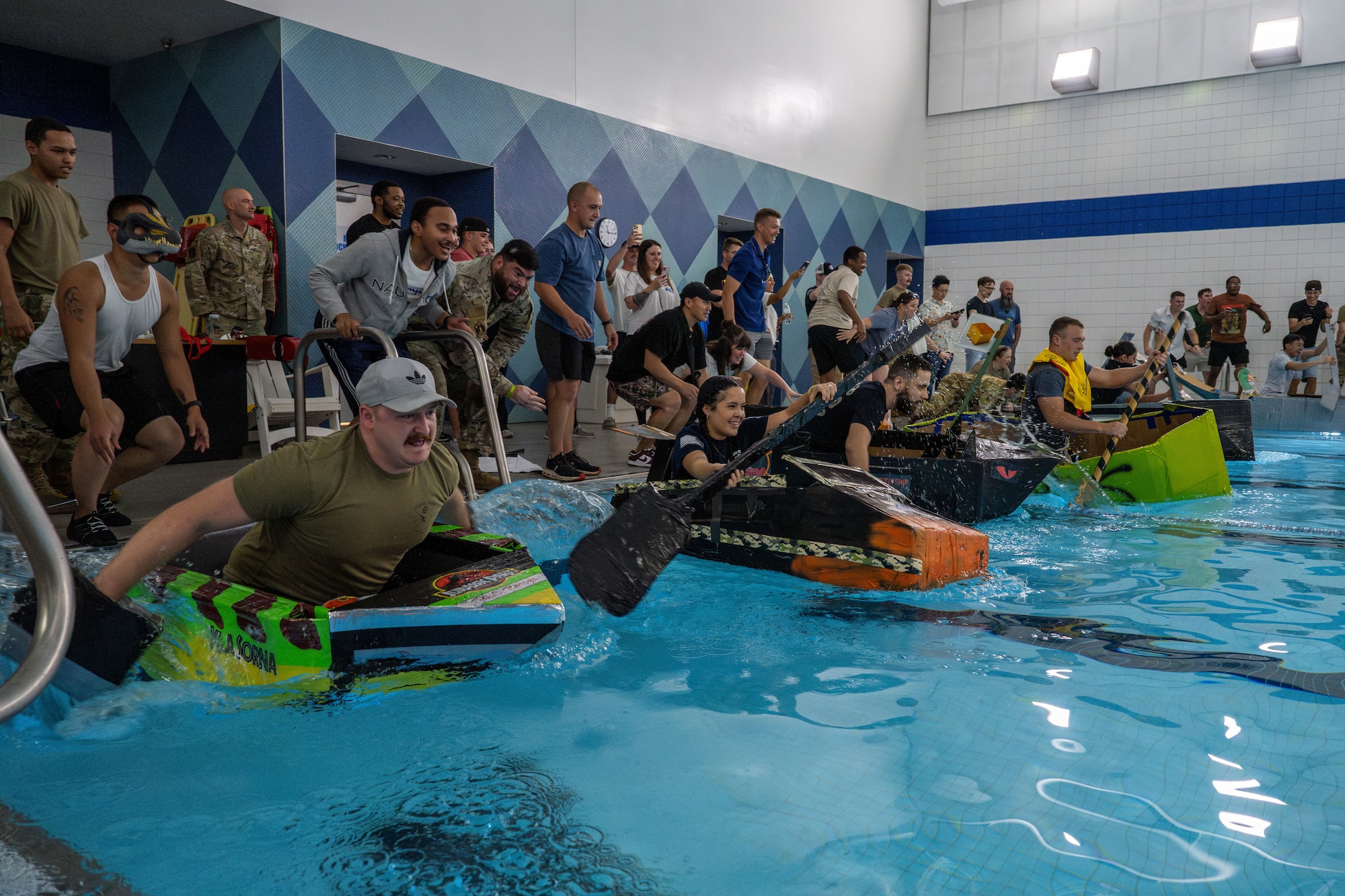 Flights from the 22nd Operations Support Squadron compete in McConnell’s cardboard race regatta at McConnell Air Force Base, Kansas, Aug. 22, 2025. Participants were permitted cardboard, tape and paint for building their competition boats. (U.S. Air Force photo by Airman 1st Class Paula Arce)