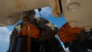 A fuels laboratory technician assigned to the 1st Special Operations Wing collects fuel samples for  processing Hurlburt Field, Florida, Aug. 7, 2025.