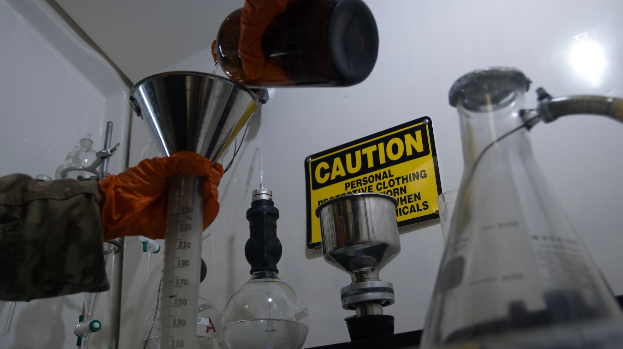 A fuels laboratory technician assigned to the 1st Special Operations Wing measures fuel and water to conduct a fuels system icing inhibitor test at Hurlburt Field, Florida, Aug. 7, 2025.