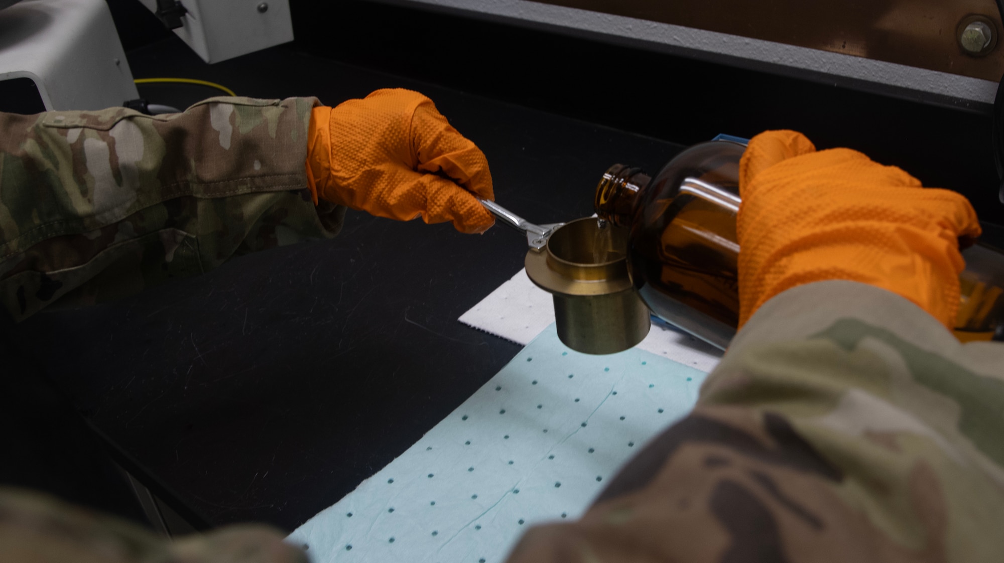 A fuels laboratory technician assigned to the 1st Special Operations Wing measures fuel for a flash point test at Hurlburt Field, Florida, Aug. 7, 2025.