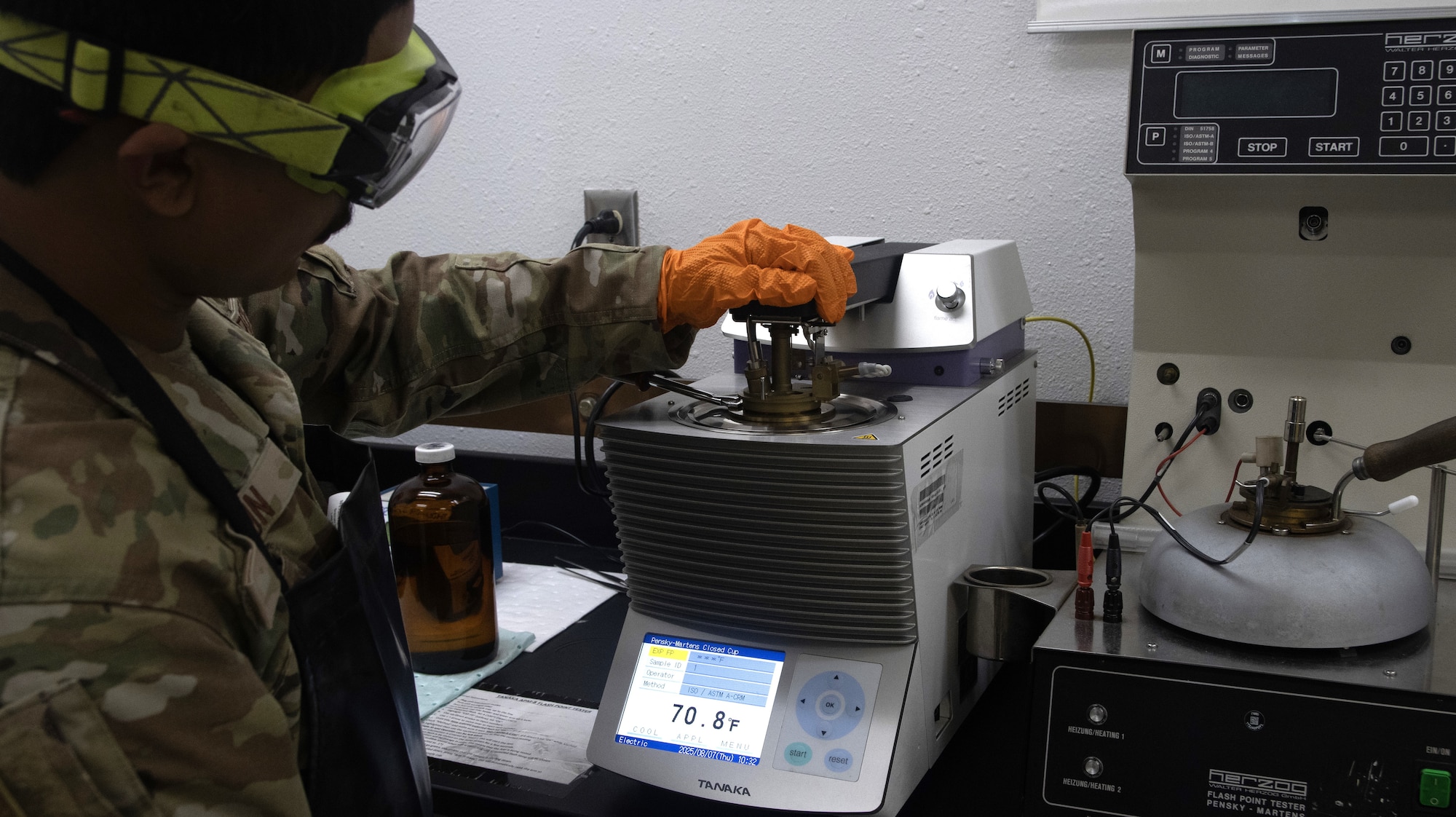 A fuels laboratory technician assigned to the 1st Special Operations Wing heats fuel in a flashpoint tester at Hurlburt Field, Florida, Aug. 7, 2025.