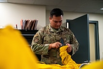 U.S. Air Force Tech. Sgt. Michael Goodwin, 9th Physiological Support Squadron (PSPTS) aircrew flight equipment technician, checks the integrity of one of the full pressure suits used by U-2 Dragon Lady pilots at Beale Air Force Base, California, July 29, 2025