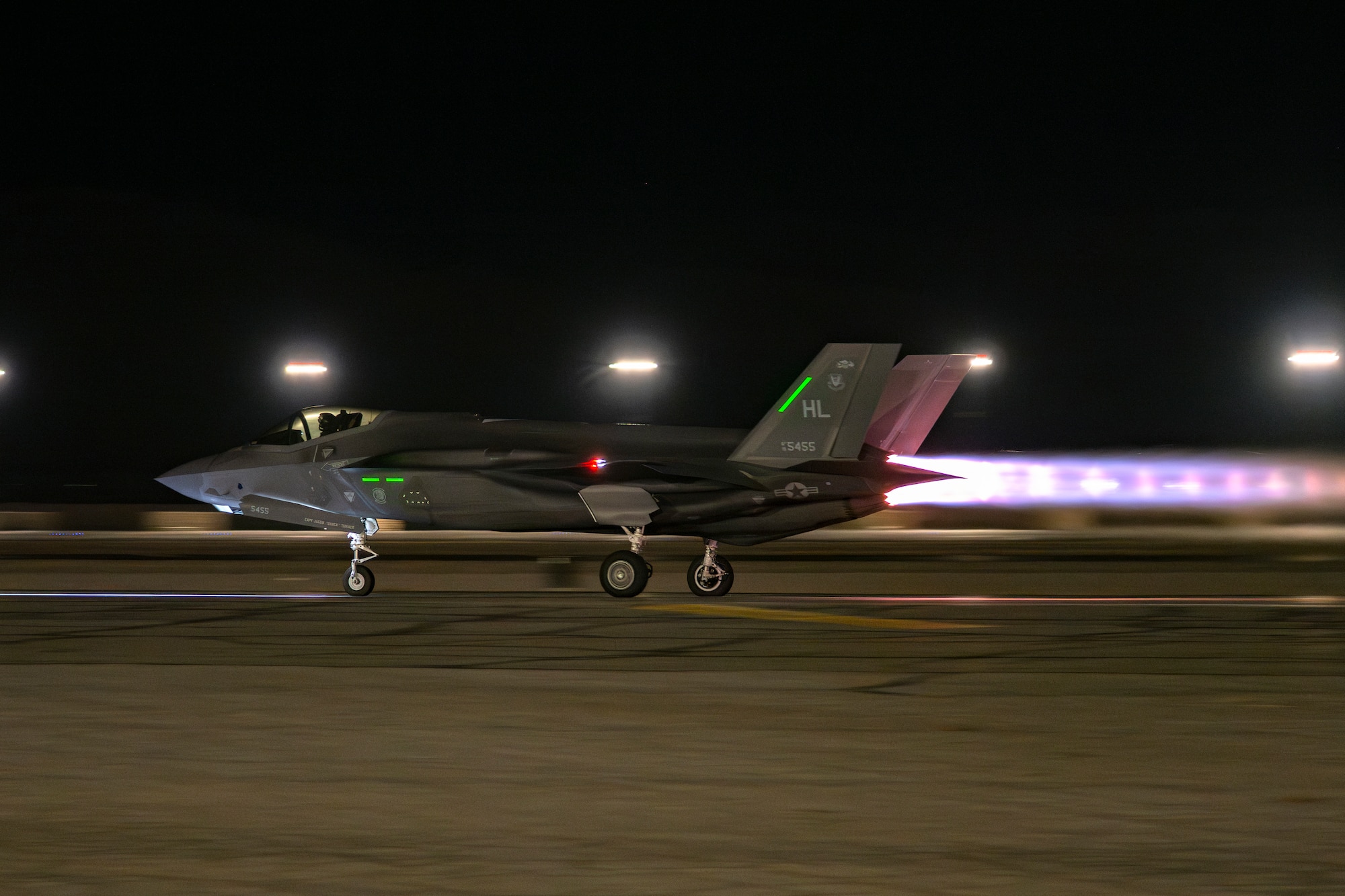 A photo of an F-35 taking off in afterburner at night