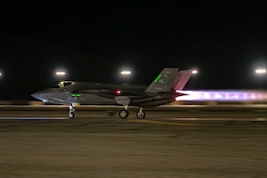 A photo of an F-35 taking off in afterburner at night