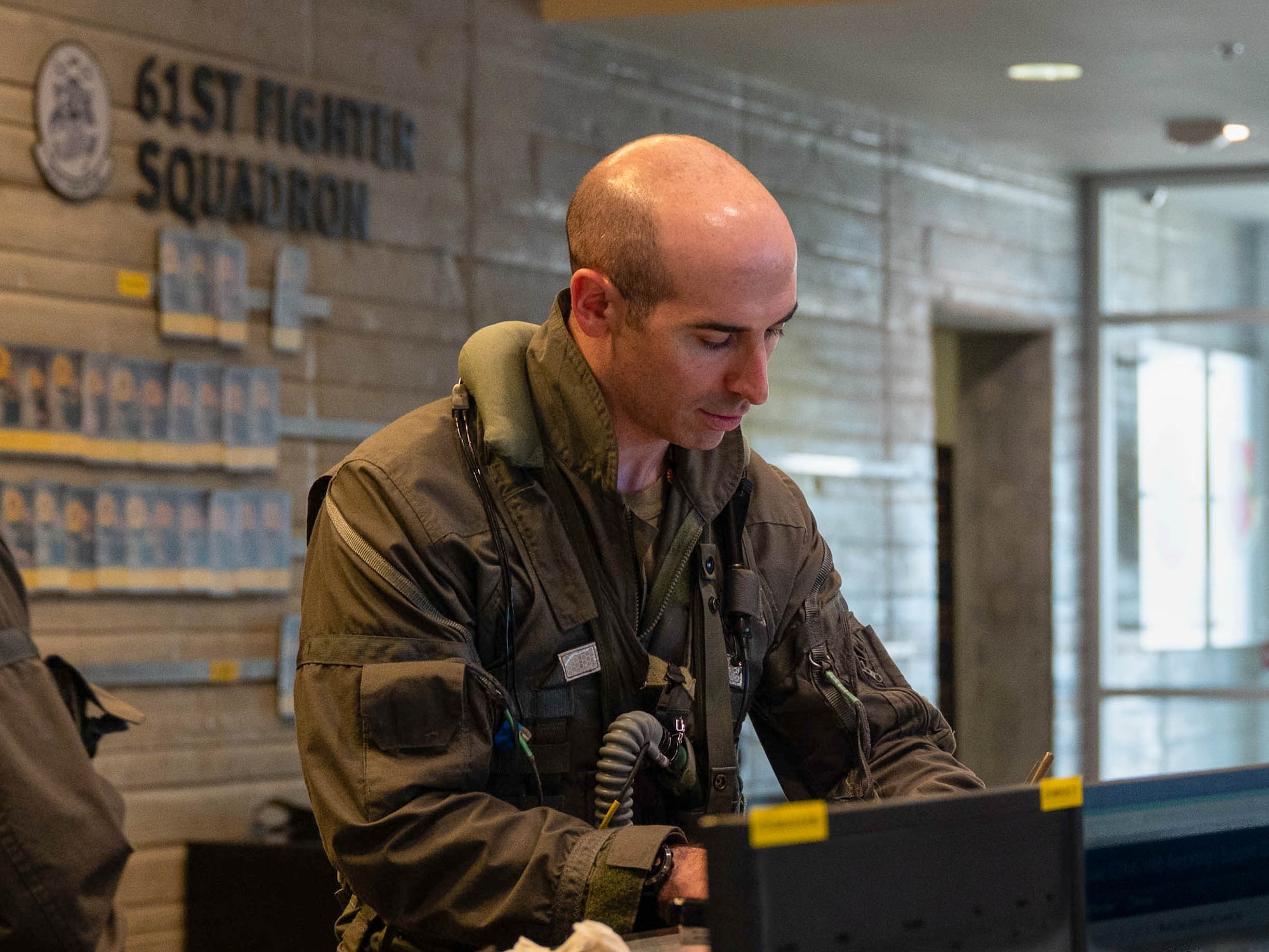U.S. Air Force Maj. Lewis Bloom, 56th Fighter Wing deputy chief of advanced programs, attends a preflight briefing inside the 61st Fighter Squadron, Aug. 12, 2025, at Luke Air Force Base, Arizona.