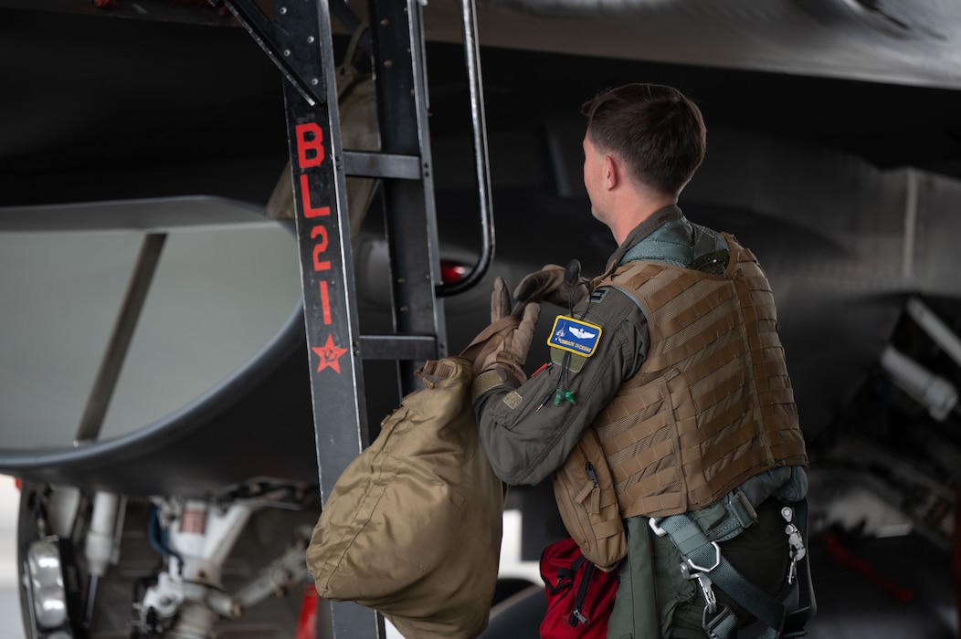 U.S. Air Force Capt. James Dickens, 18th Fighter Interceptor Squadron pilot and assistant director of operations, prepares to board a F-16 Fighting Falcon at Eielson Air Force Base, Alaska, August 25, 2025.
