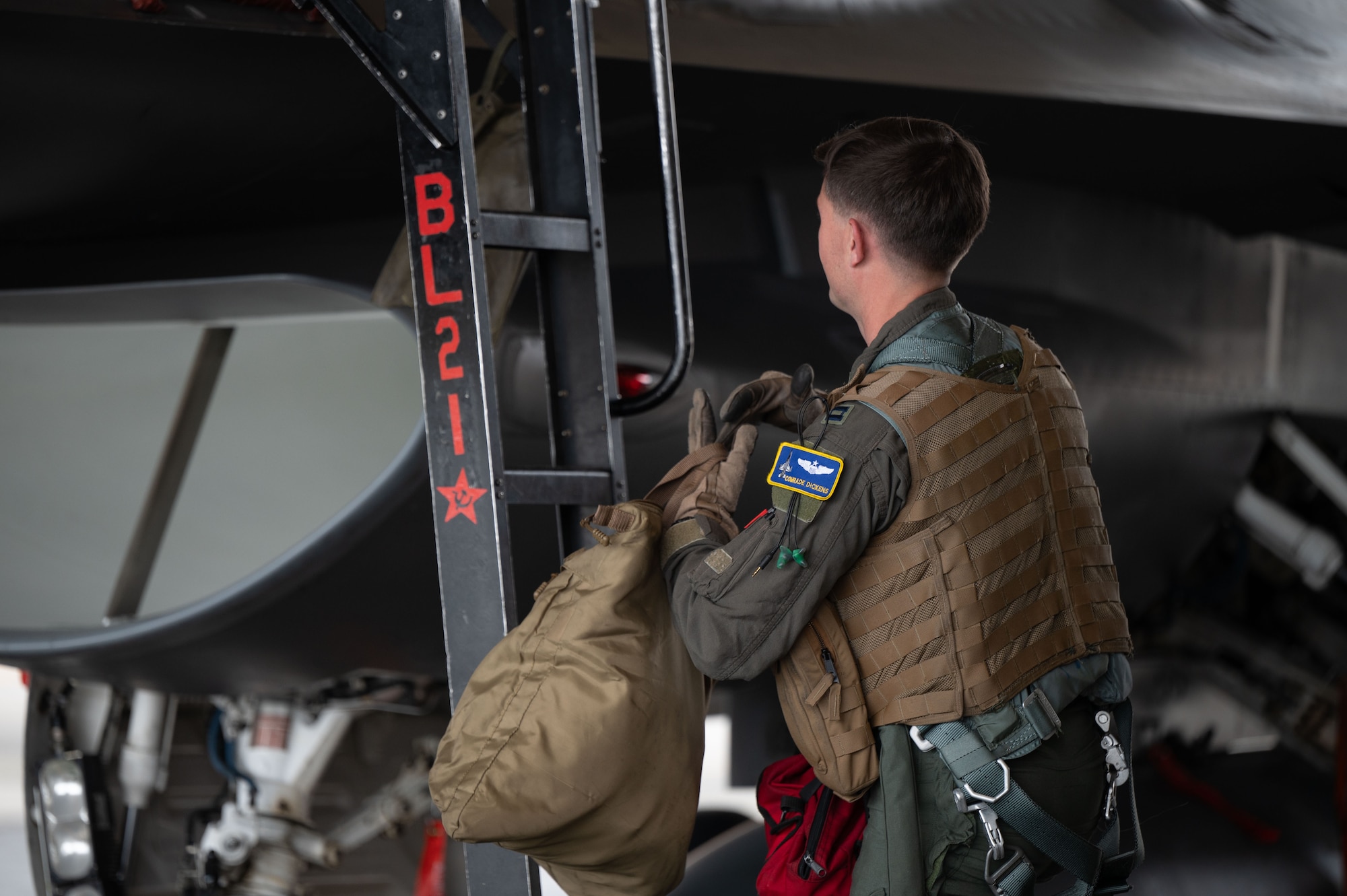 U.S. Air Force Capt. James Dickens, 18th Fighter Interceptor Squadron pilot and assistant director of operations, prepares to board a F-16 Fighting Falcon at Eielson Air Force Base, Alaska, August 25, 2025.