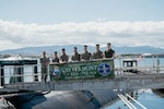 Capt. Chris Hedrick, commander, Submarine Squadron 1, left, Col. Gabriel L. Diana, 3rd Marine Littoral Regiment commanding officer, second from left, and staff pose for a photo on the brow before a tour of the Virginia-class fast-attack submarine USS Vermont (SSN 792) on Joint Base Pearl Harbor-Hickam, Aug. 14, 2025.