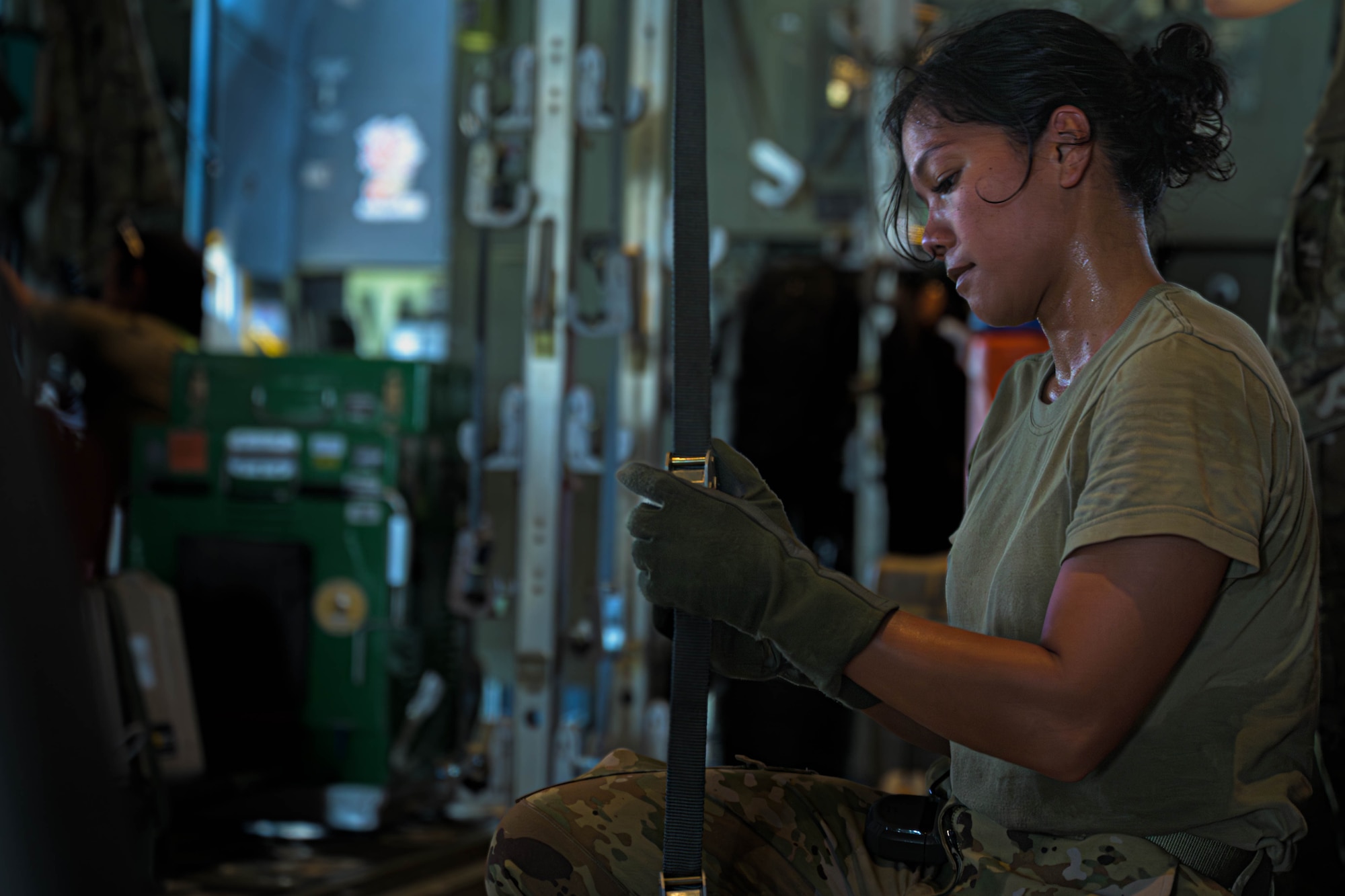 U.S. Air Force Capt. Mary Claire Coleman, 18th Aeromedical Evacuation Squadron flight nurse, helps configure a litter setup on a C-130J Super Hercules assigned to the Kentucky Air National Guard 165th Airlift Squadron, during a mass casualty training event at Yokota Air Base, Japan, July 22, 2025. The 18th AES worked alongside the 3rd Marine Division and the 165th AS to treat and load 57 role players simulated as patients
