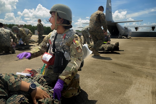 U.S. Air Force Capt. Mary Claire Coleman, 18th Aeromedical Evacuation Squadron flight nurse, treats a simulated patient during a mass casualty training event in the Indo-Pacific region, July 22, 2025. The training supports interoperability and medical readiness goals by preparing crews for future missions and operational challenges in the Indo-Pacific