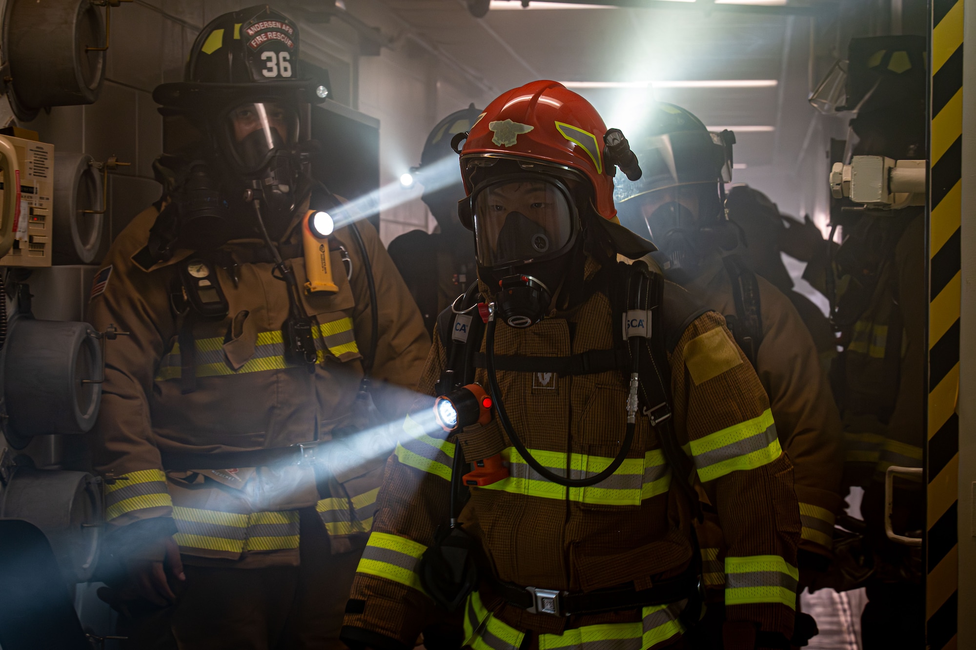 Firefighters walk through a building