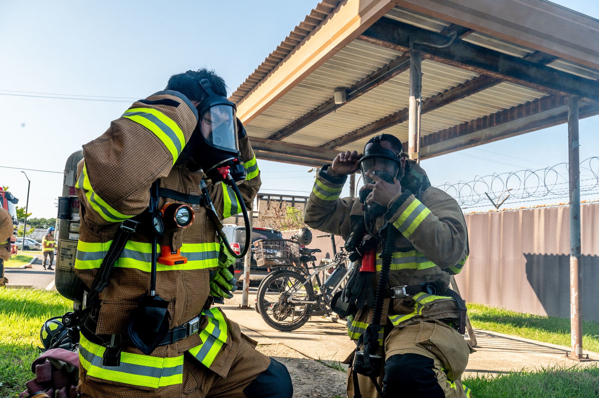 Two firefighters put on masks