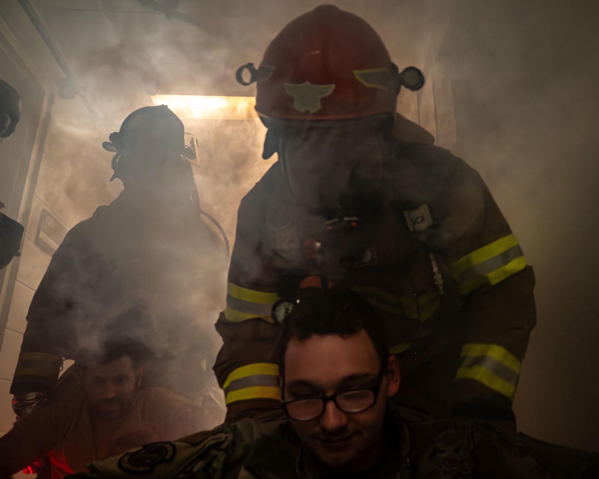 A Firefighter drags a man through smoke
