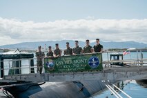 Capt. Chris Hedrick, commander, Submarine Squadron 1, left, Col. Gabriel L. Diana, 3rd Marine Littoral Regiment commanding officer, second from left, and staff pose for a photo on the brow before a tour of the Virginia-class fast-attack submarine USS Vermont (SSN 792) on Joint Base Pearl Harbor-Hickam, Aug. 14, 2025.