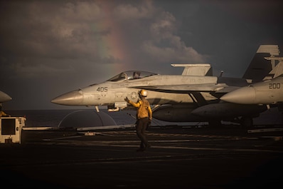 PHILIPPINE SEA (Aug. 22, 2025) — Sailors, assigned to air department’s flight deck crash and salvage division, direct an F/A-18E Super Hornet, attached to Strike Fighter Squadron (VFA) 27, on the flight deck of Nimitz-class aircraft carrier USS...
