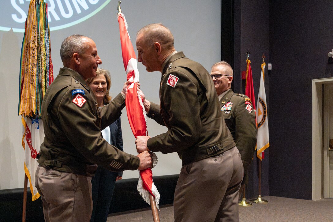 Chief of Engineers and U.S. Army Corps of Engineers Commander Lt. Gen. William H. Graham hands the division colors to Brig. Gen. John P. Lloyd during the South Pacific Division Change of Command ceremony at the California State Railroad Museum in Sacramento, Calif., on Aug. 15, 2025.