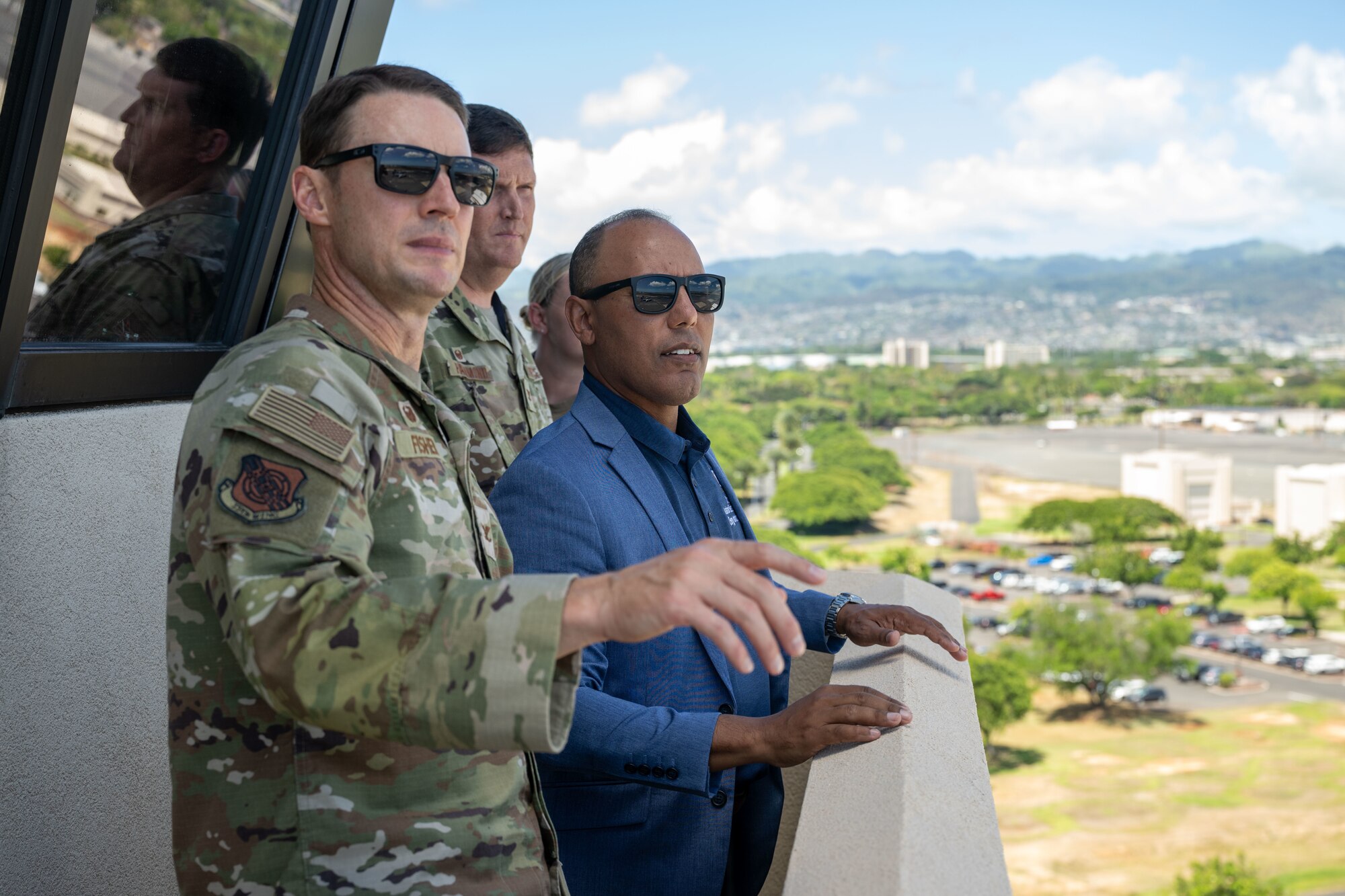 A U.S. Air Force personnel look out over the flightline on Joint Base Pearl Harbor-Hickam, Hawaii.