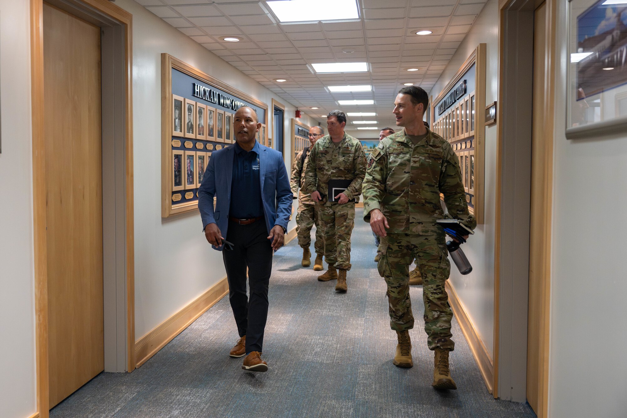 U.S. Air Force personnel walk down the 15th Wing headquarters on Joint Base Pearl Harbor-Hickam, Hawaii.