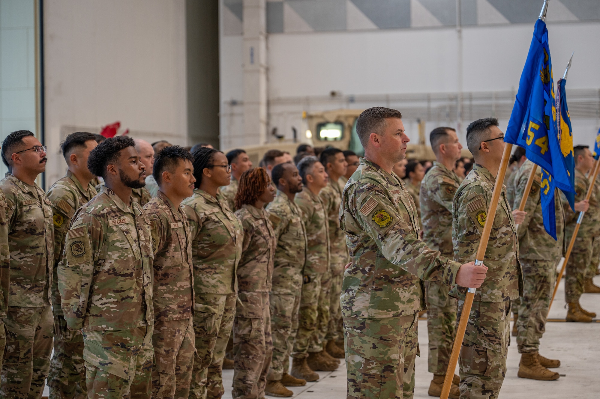 Airmen stand at parade rest for the start of a change of command ceremony.