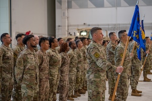 Airmen stand at parade rest for the start of a change of command ceremony.
