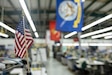 An American flag is posted near a fabrication line at Aerial Machine and Tool Corp.'s manufacturing facility in Meadows of Dan, Virginia, June 4, 2025. The company is the Army’s primary manufacturer of the Aircrew Combat Equipment (ACE) vest, currently in full-rate production under Air Soldier, Product Manager (PdM AW) Air Warrior, Project Manager Soldier Survivability (PM SSV), Program Executive Office (PEO) Soldier. (U.S. Army photo by Khylee Woodford) (Photo Credit: Khylee Woodford)