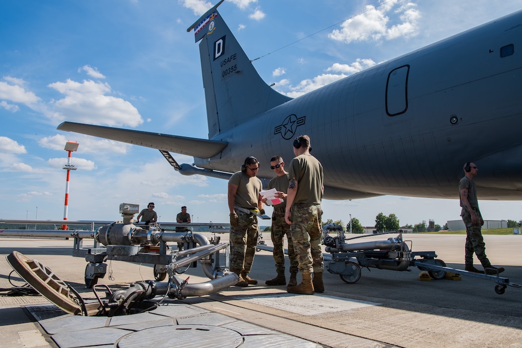 U.S. Air Force Airmen assigned to the 52nd Logistics Readiness Squadron, prepare to refuel a KC-135 Stratotanker aerial refueling aircraft assigned to the 100th Air Refueling Wing during hot refueling training.