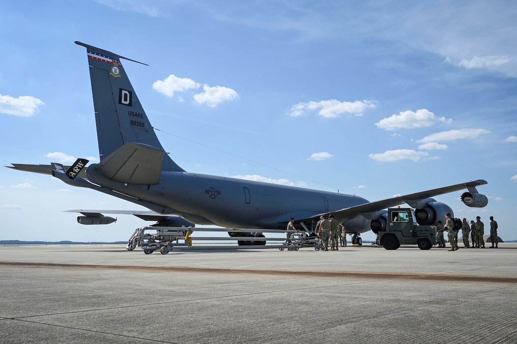 U.S. Air Force Airmen assigned to the 52nd Logistics Readiness Squadron, prepare to refuel a KC-135 Stratotanker aerial refueling aircraft assigned to the 100th Air Refueling Wing during hot refueling training.
