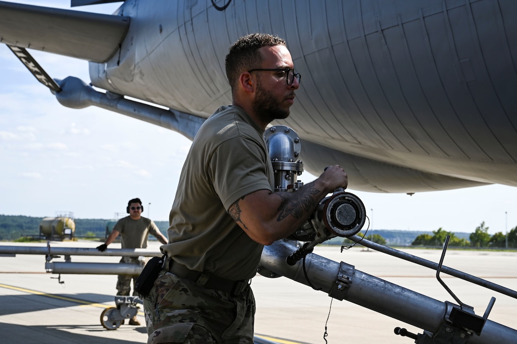 U.S. Air Force Staff Sgt. Wilmer Perez Perez, 52nd Logistics Readiness Squadron noncommissioned officer in charge of fuels hydrants, prepares to connect a mobile pantograph during hot refueling training with a KC-135 Stratotanker aerial refueling aircraft assigned to the 100th Air Refueling Wing.