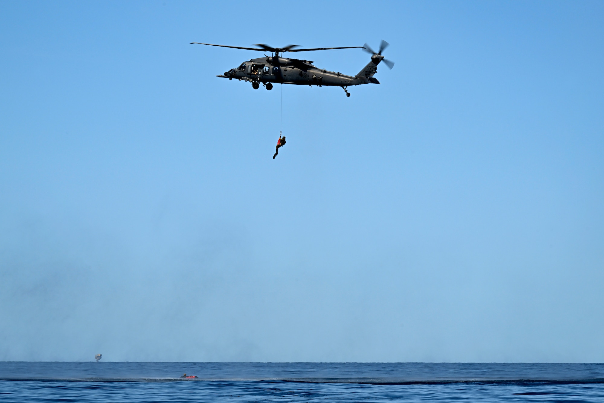 Airman is hoisted into an HH-60W Jolly Green II