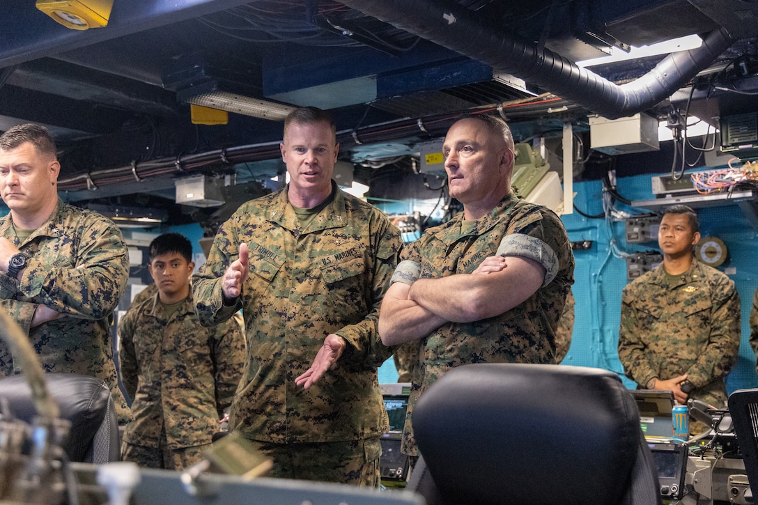 U.S. Marine Corps Col. Thomas Trimble, Commanding Officer, 22nd Marine Expeditionary Unit (Special Operations Capable), briefs Brigadier General Thomas Armas, Deputy Commanding General, Marine Forces Command, during his visit aboard the Wasp-class amphibious assault ship USS Iwo Jima (LHD 7), for a visit in Naval Station Norfolk, Virginia on August 21, 2025. The 22nd MEU(SOC), embarked on LHD 7, hosted Brigadier General Armas to provide a ship tour and to discuss the 22nd MEU(SOC)’s capabilities. (U.S. Marine Corps photo by Cpl. Sharon Errisuriz)