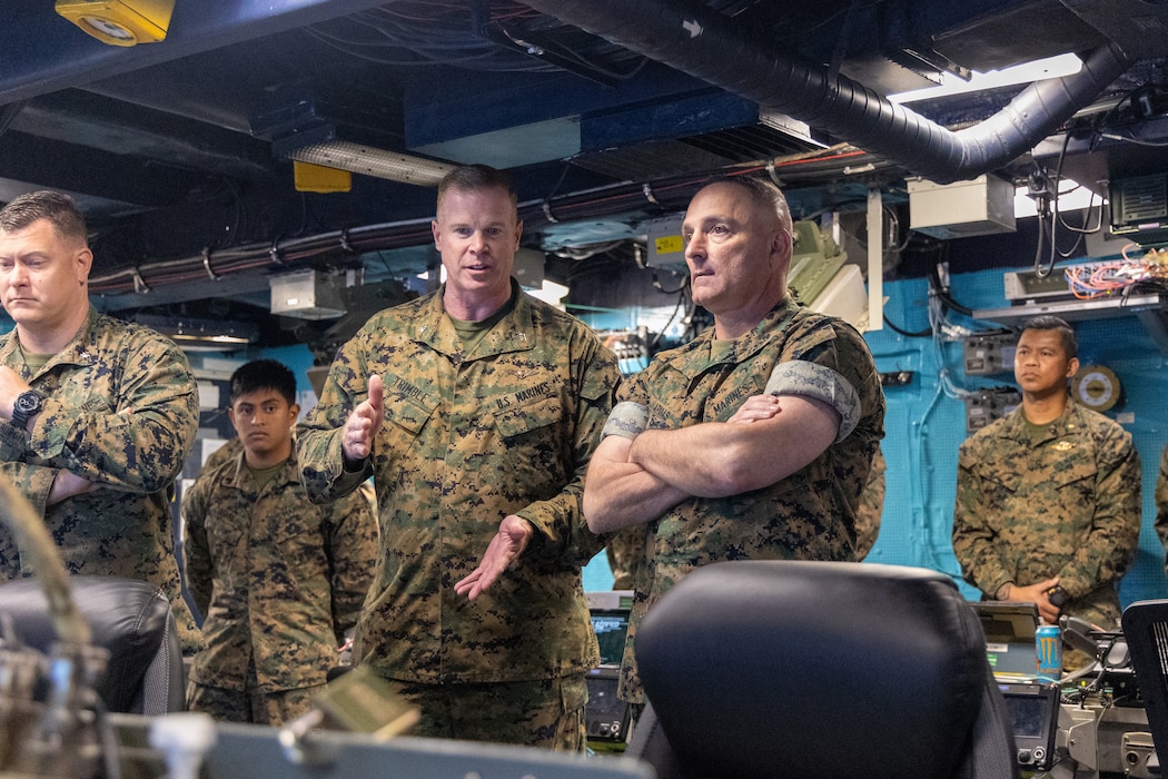 U.S. Marine Corps Col. Thomas Trimble, Commanding Officer, 22nd Marine Expeditionary Unit (Special Operations Capable), briefs Brigadier General Thomas Armas, Deputy Commanding General, Marine Forces Command, during his visit aboard the Wasp-class amphibious assault ship USS Iwo Jima (LHD 7), for a visit in Naval Station Norfolk, Virginia on August 21, 2025. The 22nd MEU(SOC), embarked on LHD 7, hosted Brigadier General Armas to provide a ship tour and to discuss the 22nd MEU(SOC)’s capabilities. (U.S. Marine Corps photo by Cpl. Sharon Errisuriz)