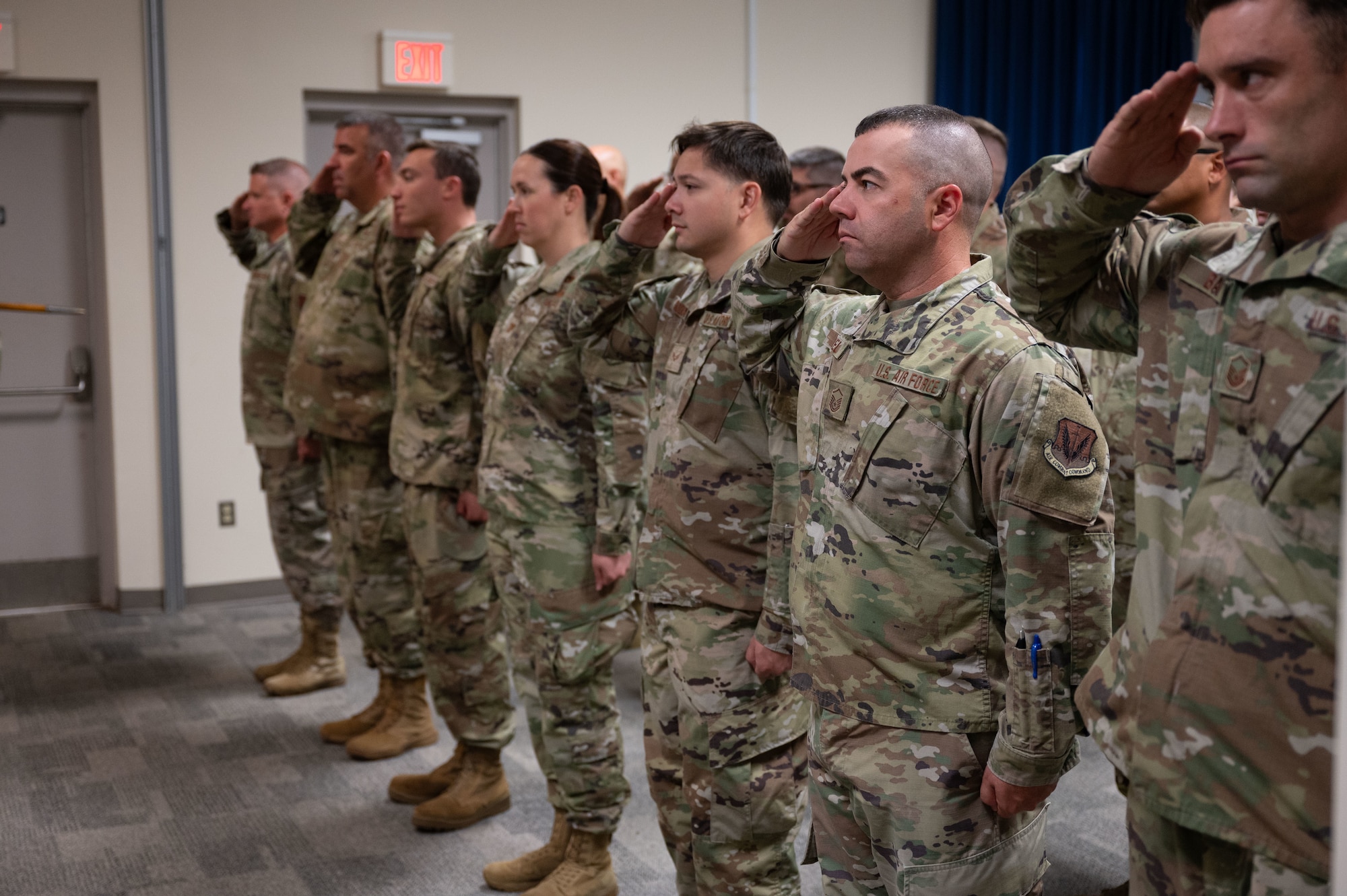Airmen salute in formation.