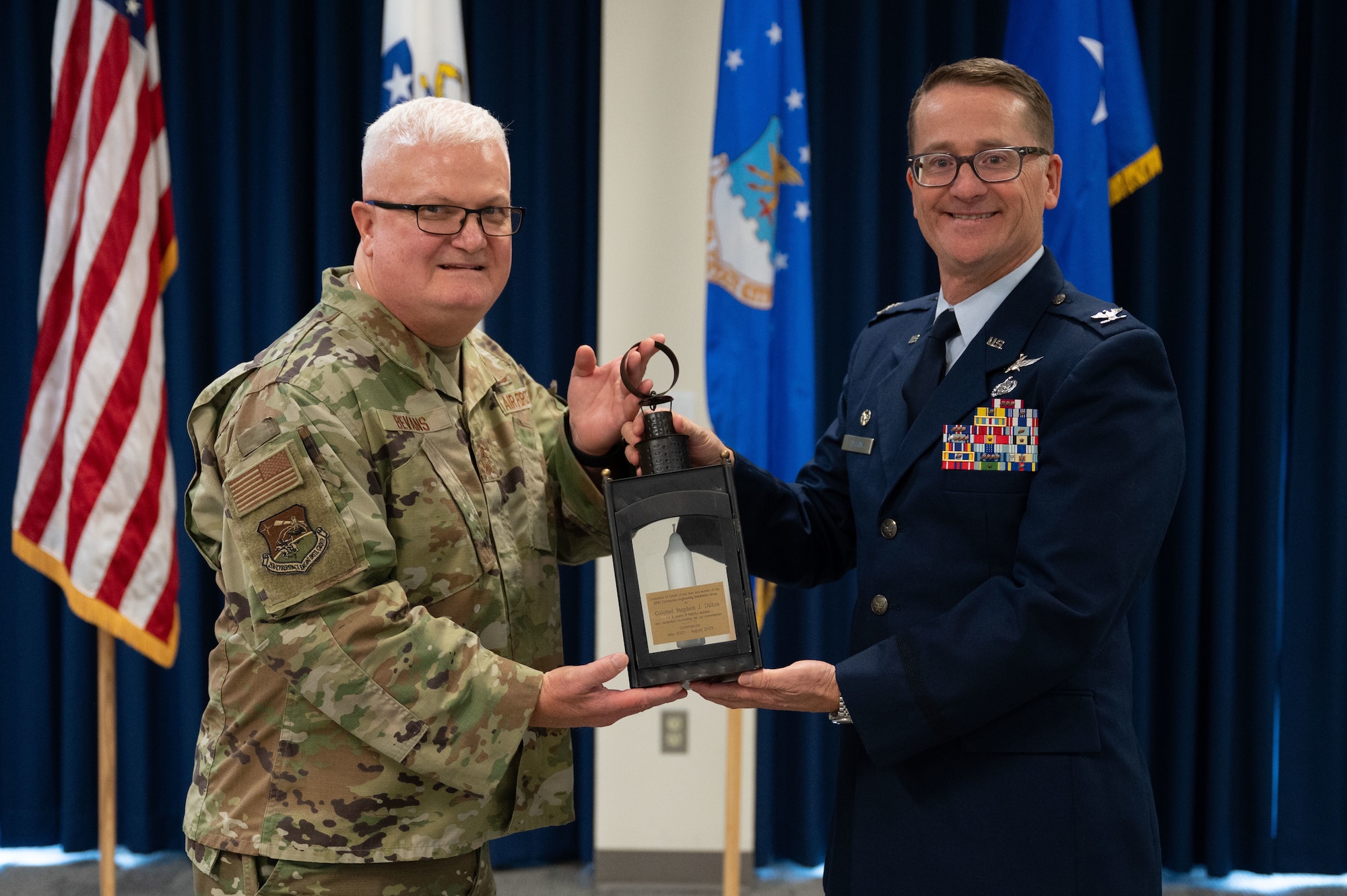 Airmen hold a lantern.