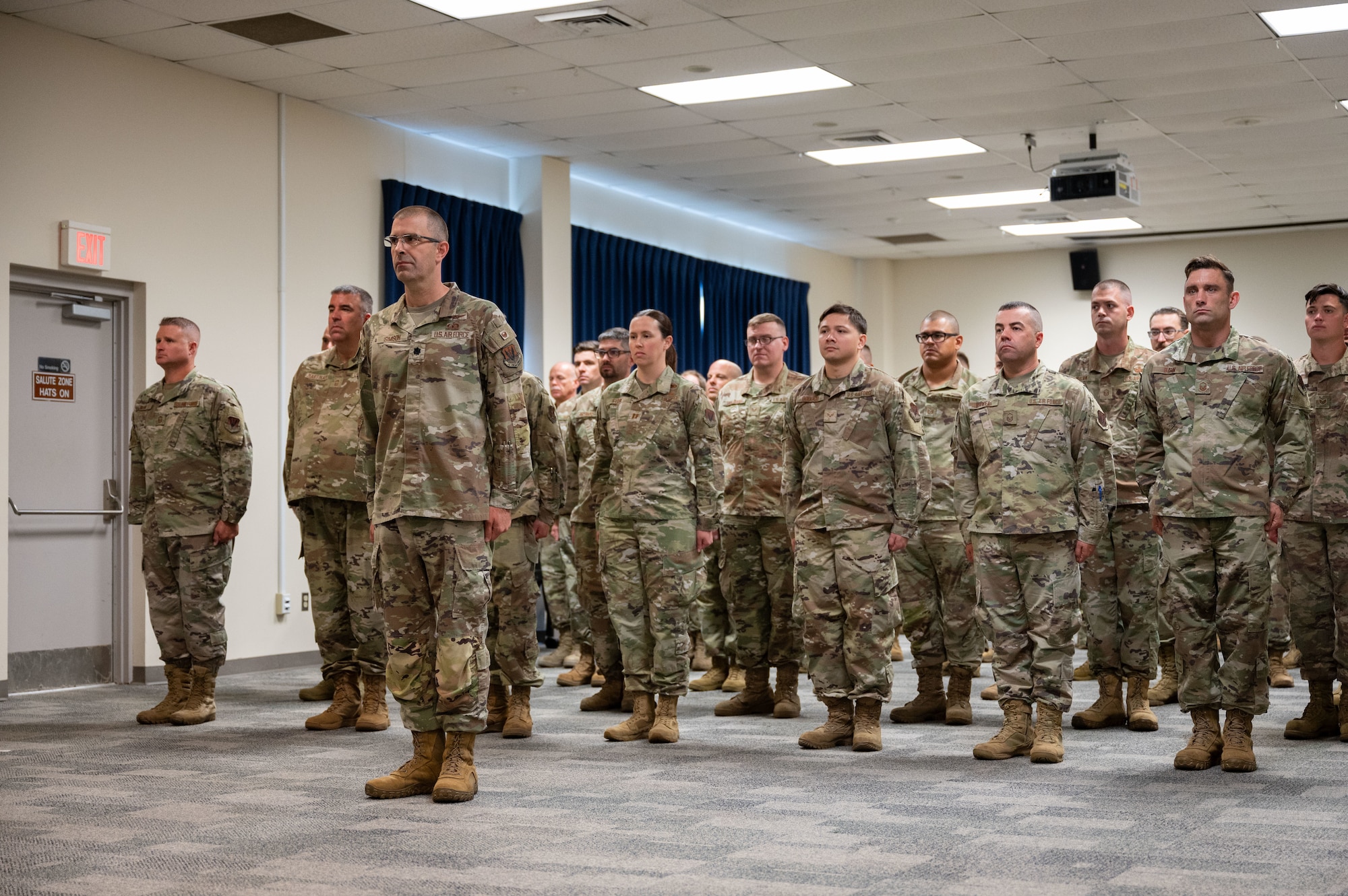 Airmen stand in formation.
