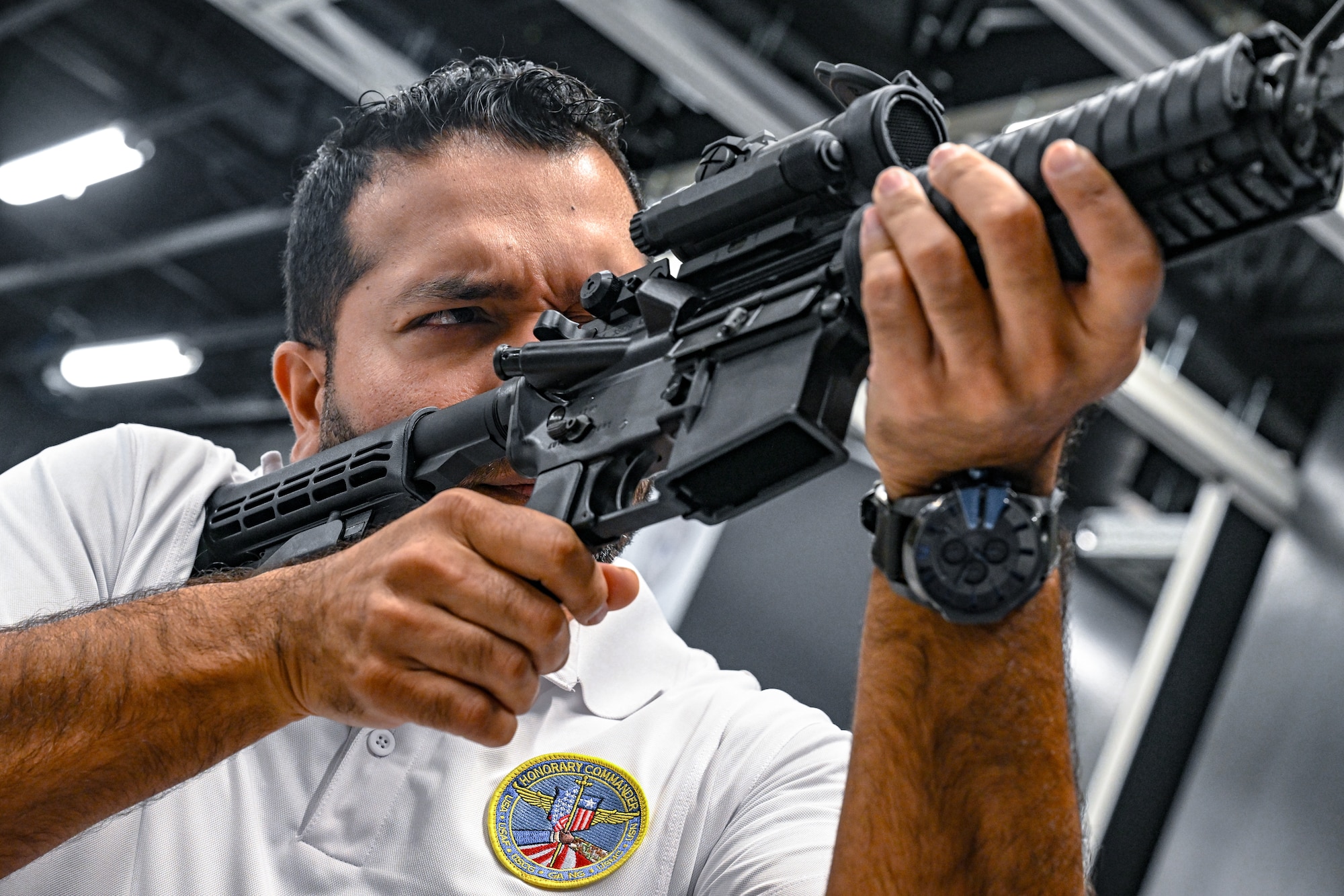A civic leader from Dobbins Air Reserve Base, Georgia, holds an M4 carbine rifle during a weapons familiarization tour on Aug. 14, 2025, at Youngstown Air Reserve Station, Ohio.
