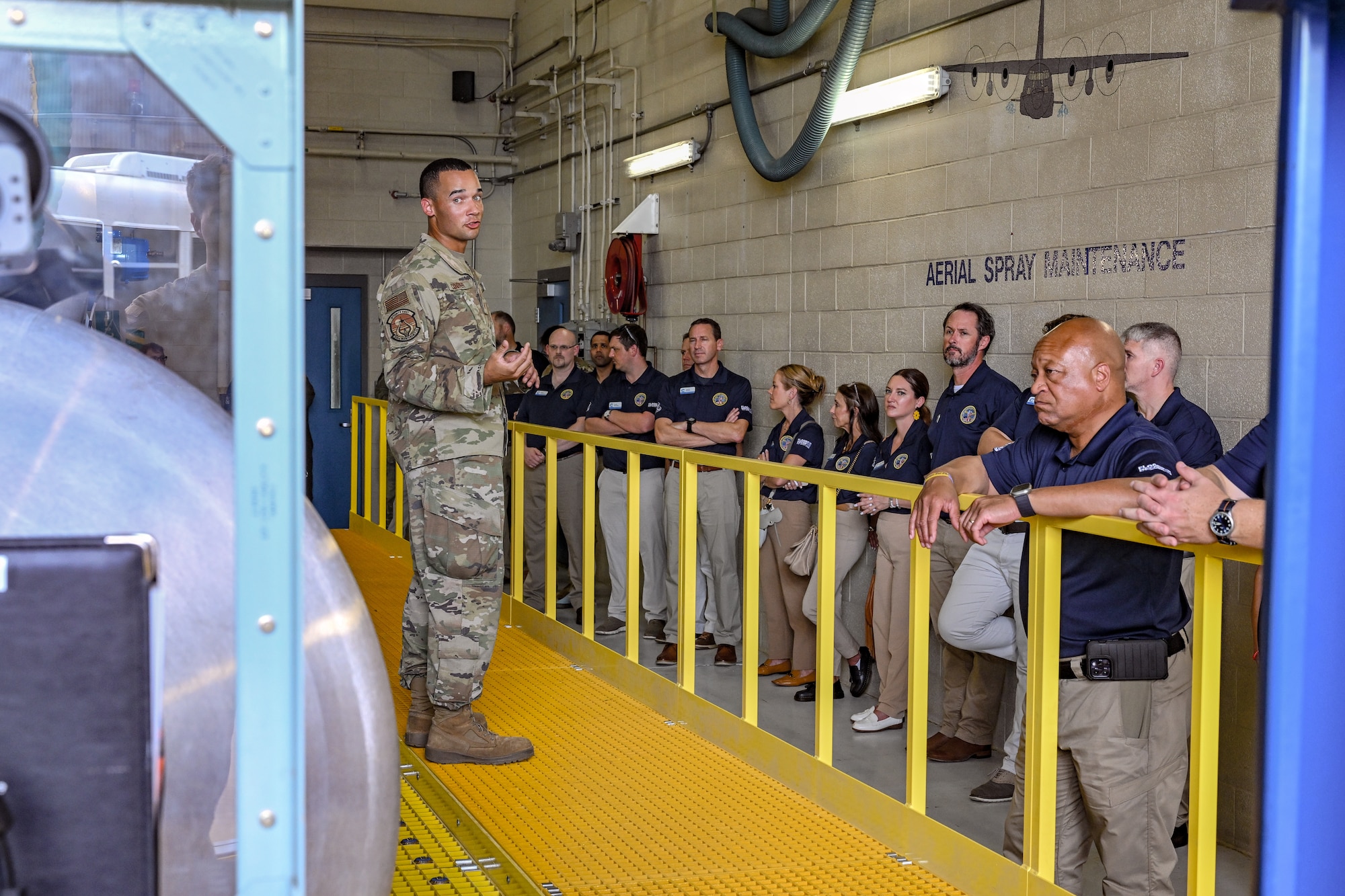 Tech. Sgt. Bryce Cooper, an aerial spray maintenance technician with the 910th Maintenance Squadron, gives an aerial spray briefing to civic leaders from Dobbins Air Reserve Base, Georgia, on Aug. 13, 2025, at Youngstown Air Reserve Station, Ohio.